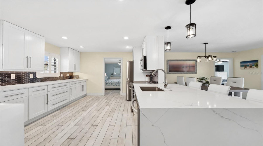 Beautiful Tile Backsplash And Quartz Countertop With Waterfall Edge