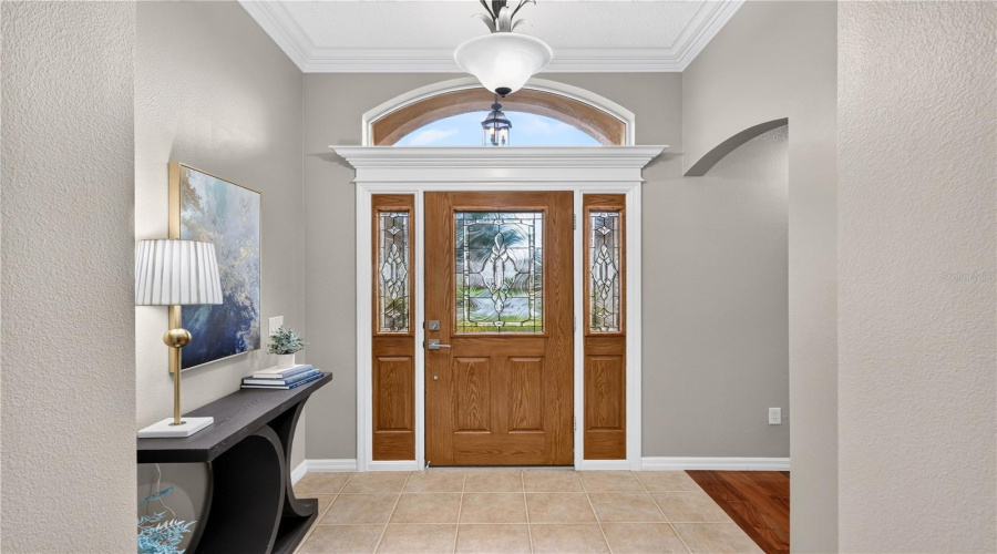 Elegant Entry Foyer With Double Glass Front Doors, Tray Ceiling Detail, And A Welcoming First Impression.