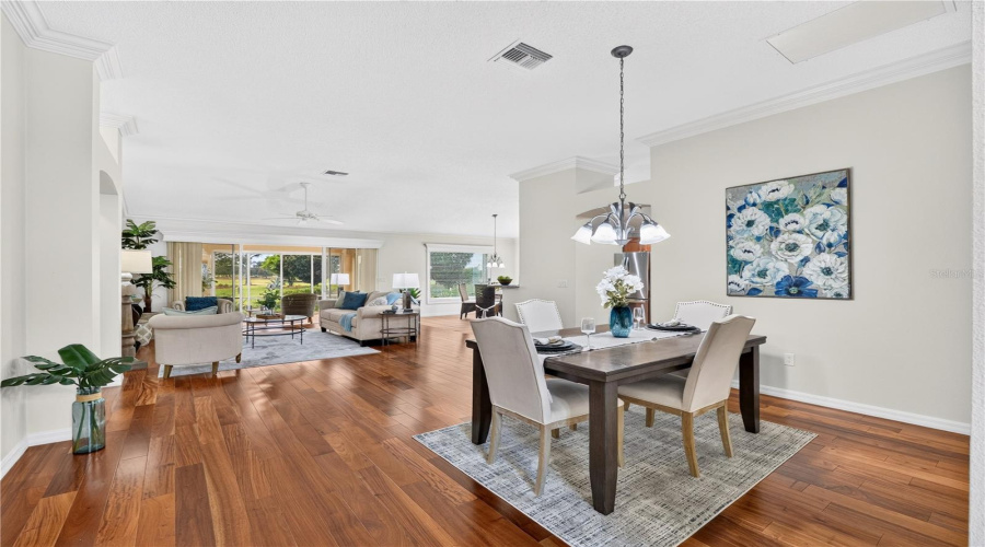 Open Dining Area With Beautiful Wood Flooring, High Ceilings, And An Easy Flow Into The Living Room And Kitchen.