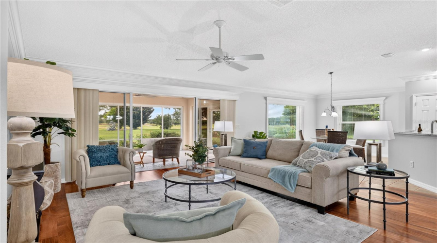 Inviting Living Room With An Open Layout, Abundant Natural Light, And Seamless Connection To The Dining And Kitchen Areas.
