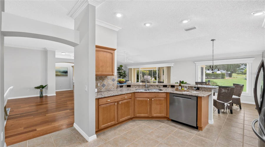 Kitchen View Showcasing The Open Layout, Generous Counter Space, Stainless Steel Dishwasher, And Convenient Connection To The Main Living Areas.