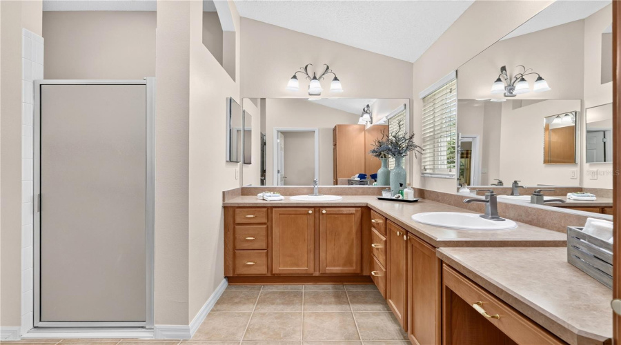 Primary Bathroom Featuring Dual Vanities, Abundant Counter Space, Separate Shower, And A Spacious Layout.
