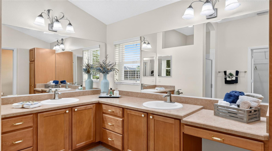 Dual-Sink Vanity With Wood Cabinetry, Large Mirrors, And Excellent Storage In The Primary Bath.