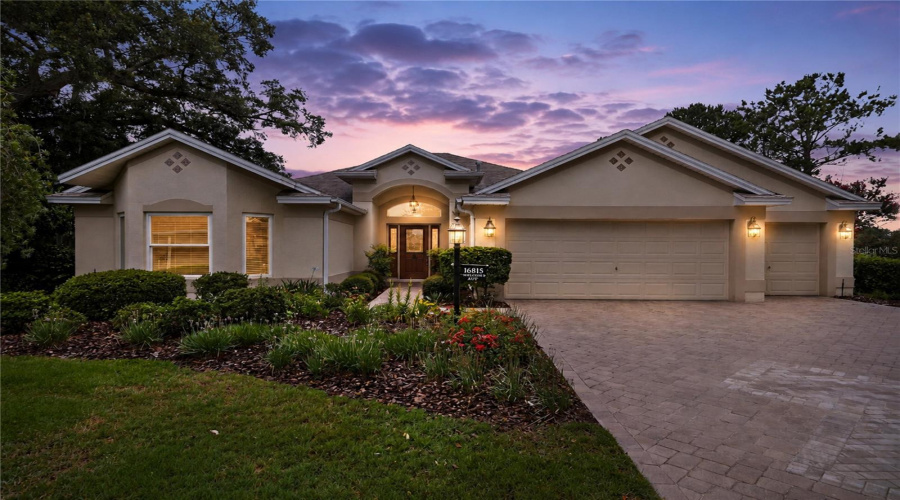 Evening Exterior View Showing The Home Beautifully Lit At Dusk, Creating A Warm And Inviting First Impression.