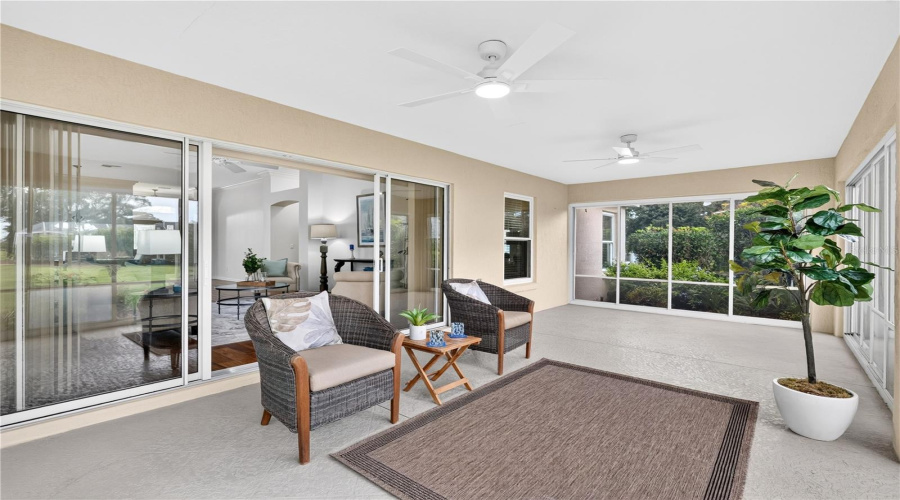 Bright Enclosed Lanai With Sliding Glass Doors, Ceiling Fan, And Plenty Of Room For Relaxing Or Entertaining.