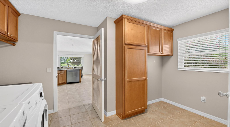 Laundry And Utility Area With Cabinetry, Natural Light, And Additional Flexible Space For Storage Or Organization.