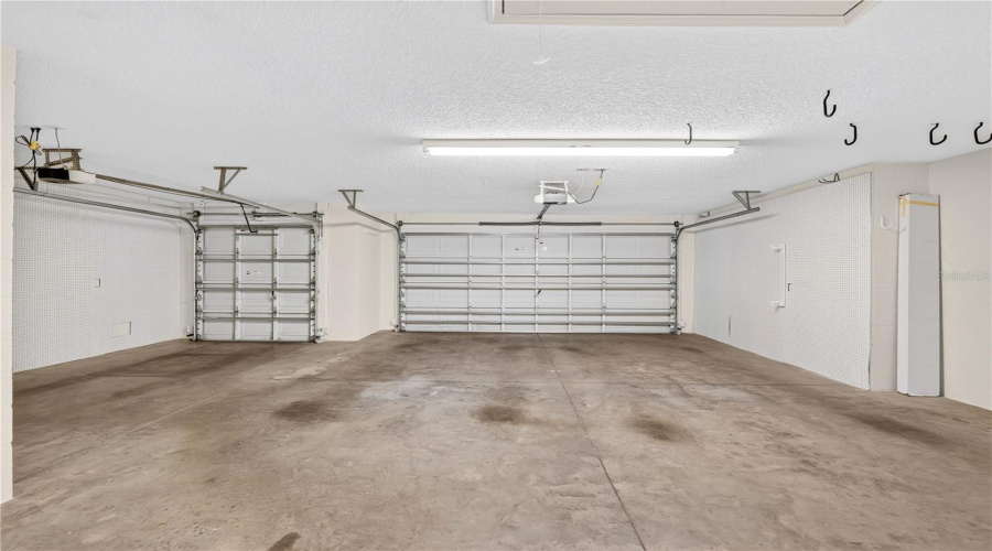 Oversized Garage View With Overhead Storage Options, Utility Access, And Plenty Of Space For Everyday Functionality.