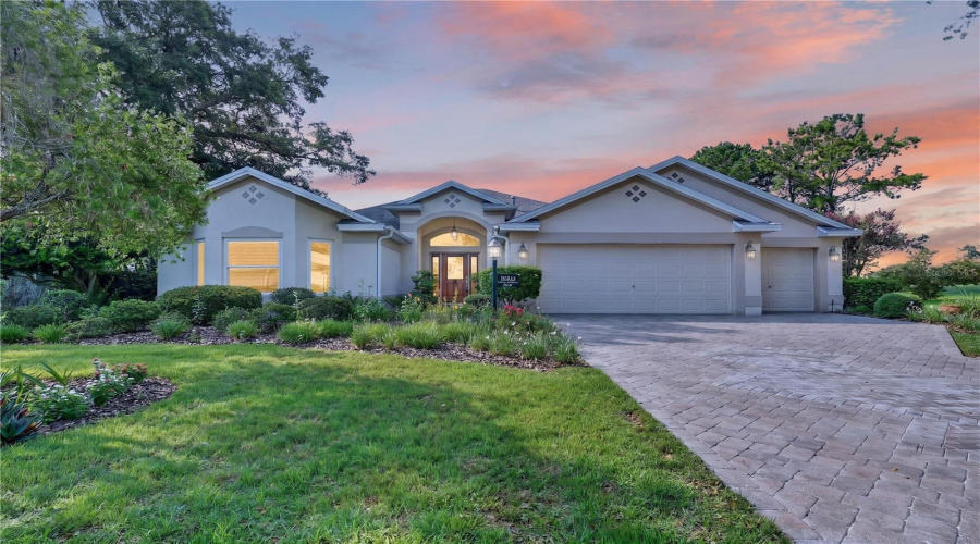 Twilight Exterior View Highlighting The Home’s Inviting Curb Appeal, Soft Evening Lighting, And Beautifully Landscaped Front Yard.