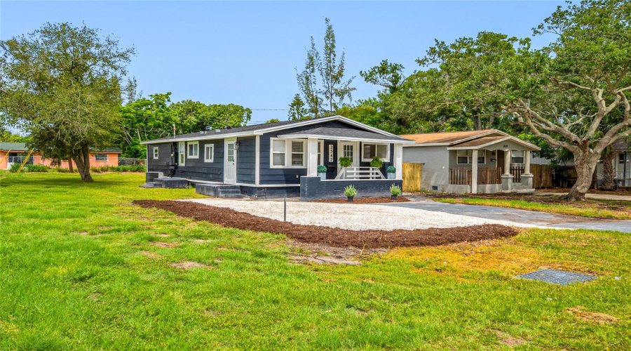 Front View Of Home With Large Driveway And Lots Of Guest Parking.