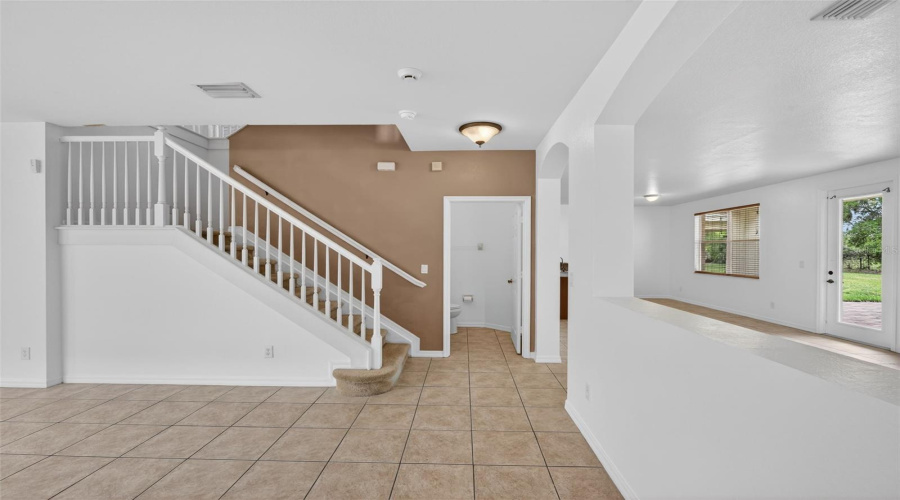 Living Room With Stairway And 1/2 Bath Downstairs