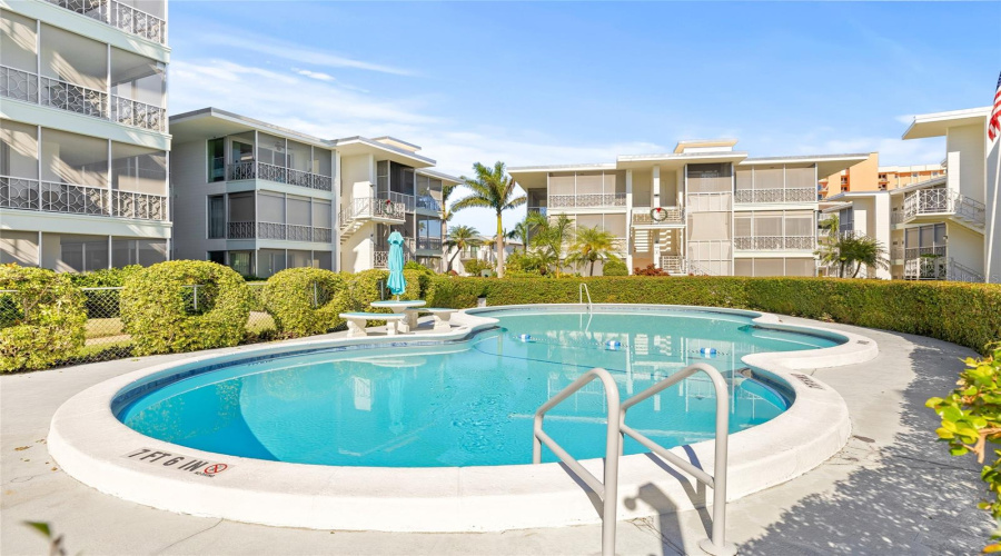 The Community Pool Is Generously Sized And Has Some Furnishings. Plenty Of Landscaping Surrounds The Pool, Giving It A Private Feel.