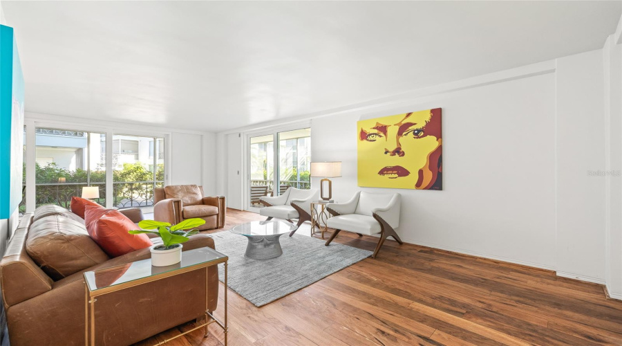 Plenty Of Natural Light Comes In Through The New High-Impact Sliding Doors That Line The Living And Dining Spaces.