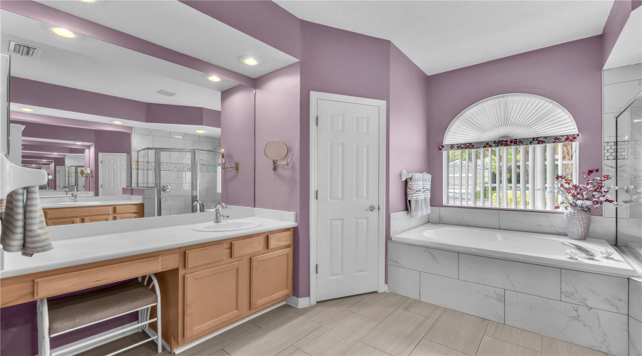 The Primary En-Suite Features Two Separate Vanities And Sinks, A Soaking Tub, And A Walk-In Shower.