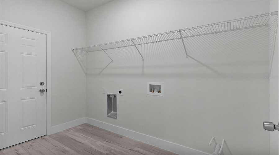 Inside Laundry Room With Plumbing In Place For Laundry Tub