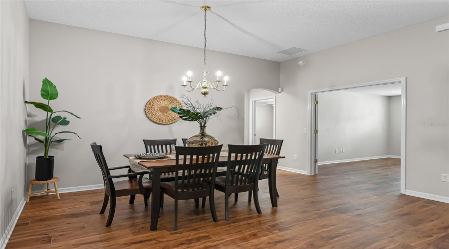 Spacious Dining Area With Vaulted Ceiling, Decorative Lighting, And Newer Wood-Look Lvp Flooring—Plenty Of Room For Gathering With Family And Friends.
