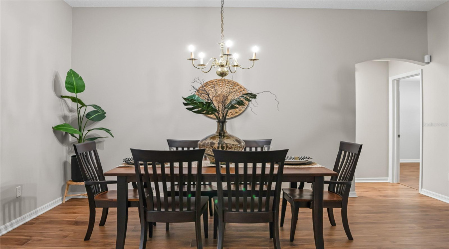 Formal Dining Space With Neutral Finishes, Attractive Chandelier, And Easy Access To The Kitchen And Main Living Areas.