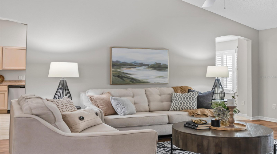 Comfortable Living Room With Vaulted Ceiling, Abundant Natural Morning Light, And A Warm, Inviting Layout Perfect For Relaxing Or Entertaining.