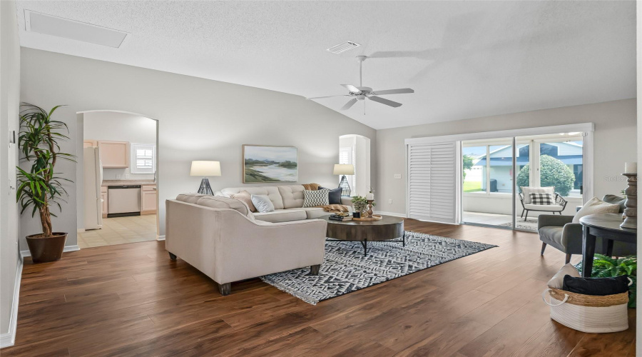 Light-Filled Main Living Area With Easy Flow To The Kitchen And Enclosed Lanai, Extending The Usable Living Space And Bringing In Wonderful Natural Light.