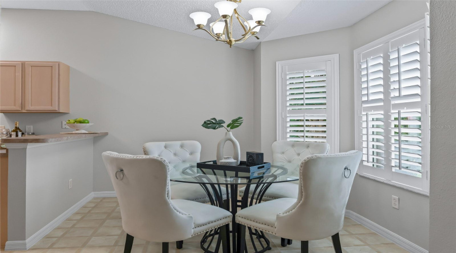 Bright Breakfast Nook With Plantation Shutters, Attractive Lighting, And Plenty Of Natural Light—An Inviting Space For Casual Dining Just Off The Kitchen.