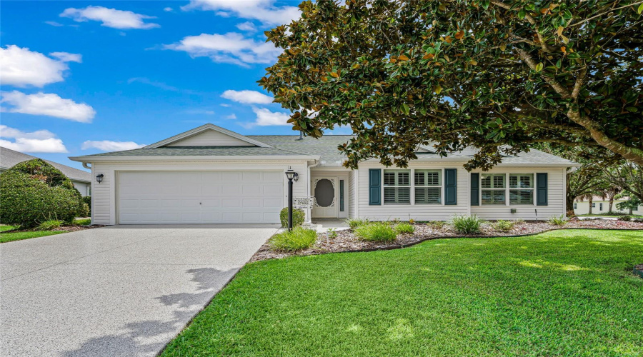 Beautiful Whispering Pine On A Desirable Corner Lot With Mature Landscaping, Attractive Shutters, And A Brand-New Textured Epoxy Driveway And Walkway. Bond Paid!