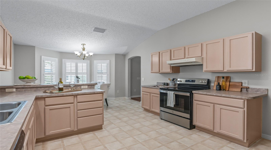 Well-Designed Kitchen Offers Plenty Of Workspace, A Breakfast Bar, Recessed Lighting, And Easy Access To Both The Dining And Living Areas. Gas Is Available Behind The Range.