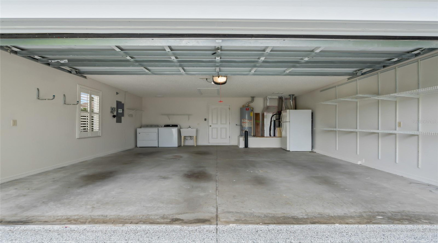 Extra-Deep 20' X 24' Two-Car Garage Provides Excellent Parking, Storage, And Workspace Potential. Includes Extra Refrigerator!
