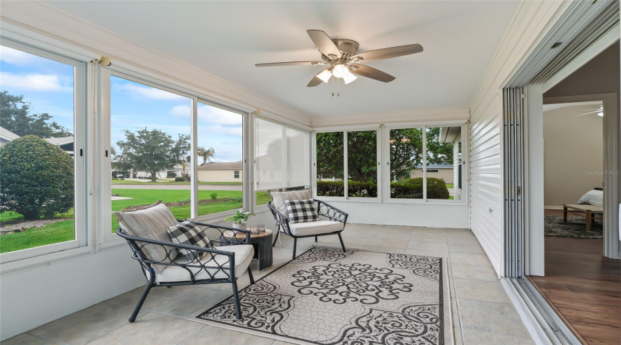 Bright East-Facing Lanai With Expansive Windows Overlooking The Backyard—An Ideal Spot For Morning Coffee While Enjoying Cooler Afternoon Shade.