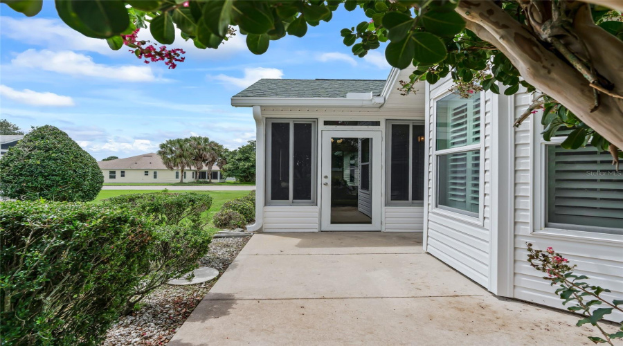 Private-Feeling Rear Patio Framed By Mature Landscaping And Convenient Access To The Enclosed Lanai.