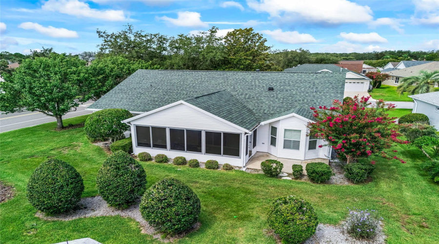 Aerial View Showcases The Home’s Attractive Corner-Lot Setting, Mature Landscaping, And Enclosed Lanai At The Rear Of The Property.