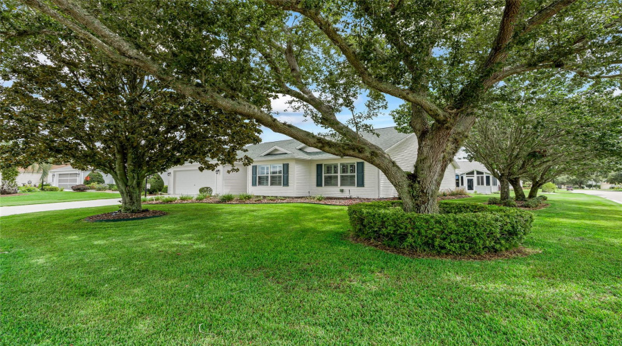 Expansive Corner Homesite Framed By Mature Shade Trees And A Beautifully Maintained Lawn—An Appealing Setting With Wonderful Outdoor Presence.