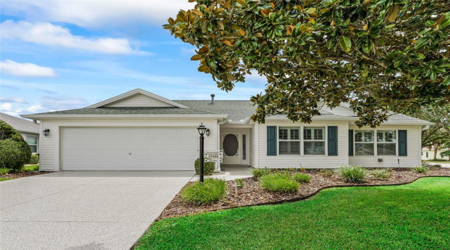 Another Inviting View Of This Well-Kept Whispering Pine Featuring Mature Landscaping, Attractive Shutters, And A Brand-New Textured Epoxy Driveway And Walkway.