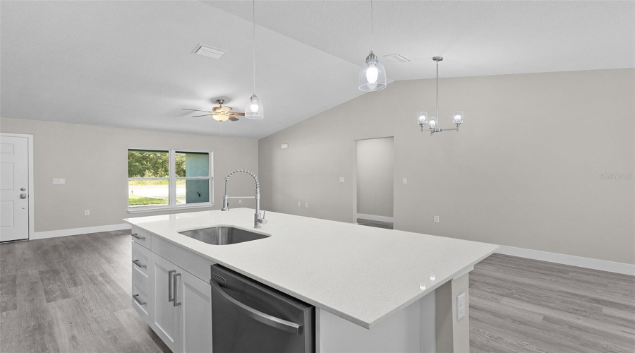 Looking Across The Kitchen Island And Breakfast Bar Toward The Front Of The Home