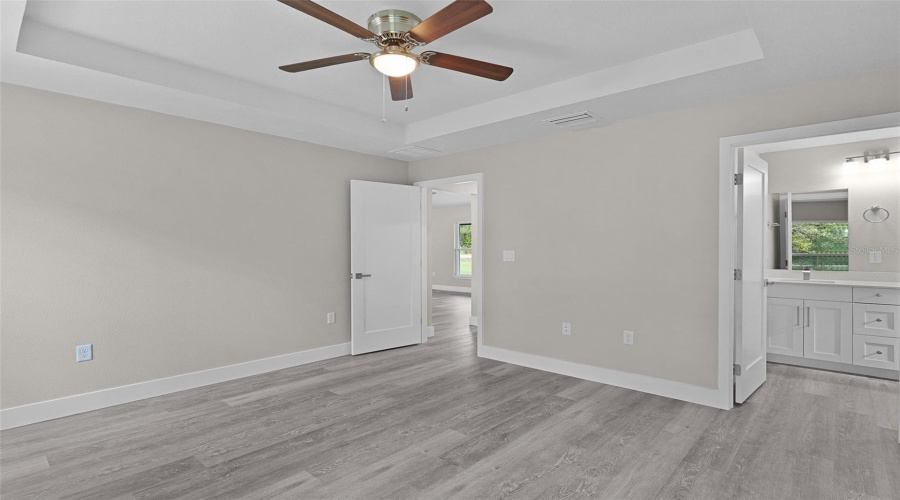 Primary Bedroom Looking Toward Living Area With Ensuite Bathroom On The Right