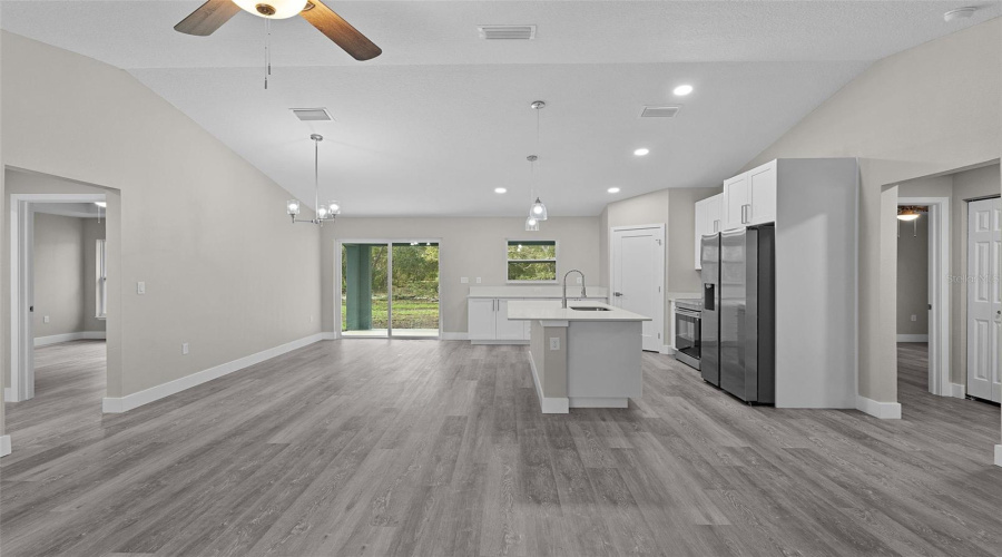 Kitchen And Dining Area From The Living Room. Primary Bedroom Is To The Left And Bedrooms 2 And 3 Are To The Right.
