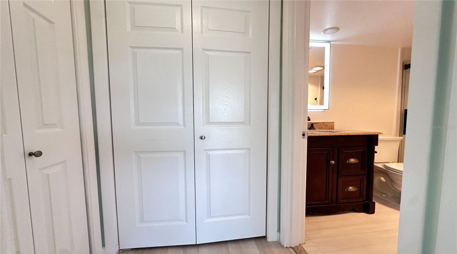 Hall With Two Closets Leads To En Suite For Second Bedroom