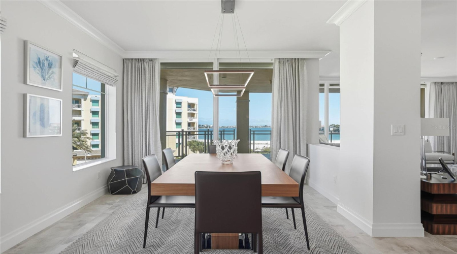 Dedicated Dining Area With A Cool, Modern Chandelier And Magnificent Water Views.
