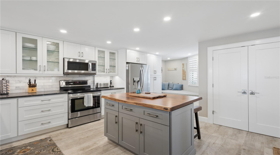 Kitchen With Custom Wood Island Countertop And Daybed
