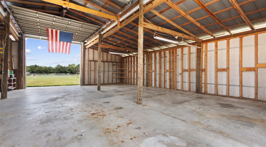 Empty Garage With Dual Overhead Doors For Pass Through