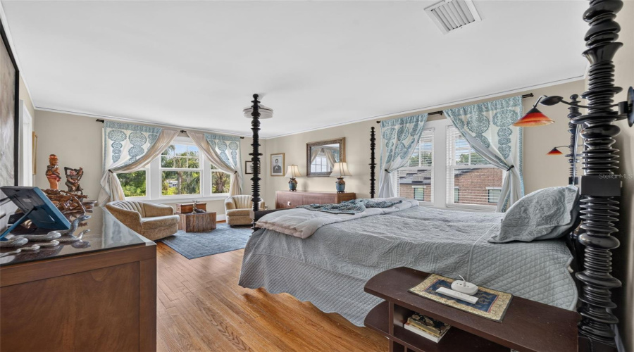 Primary En-Suite Bedroom With Sitting Area Overlooking Lake