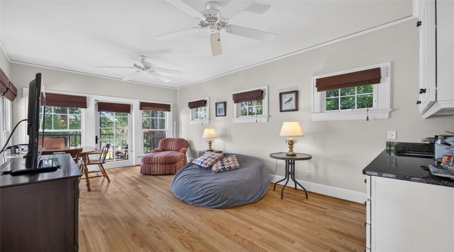 Living Room And Kitchenette In Guest House Situated Under The Trees With Screened Porch On Lake