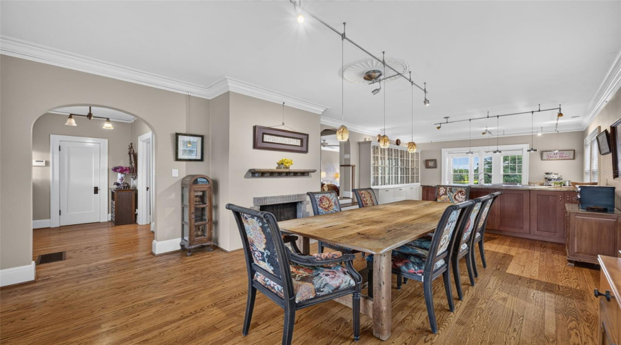 View To Foyer From Dining Room; Kitchen With Custom Glass Front Cabinetry Leads To Sitting Area Overlooking Lake