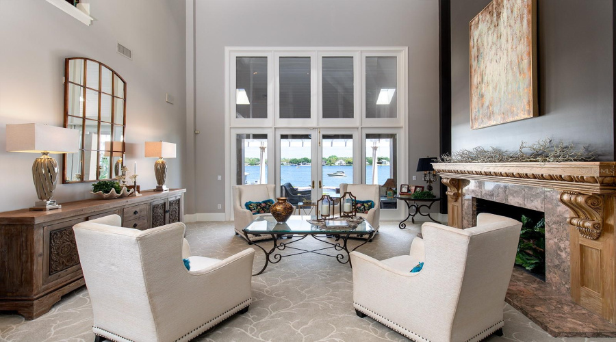 Formal Living Room Is Stately And Impressive With Its Marble Fireplace And Hand Carved Mantel And Panoramic Water Views That Welcome The Outside In.