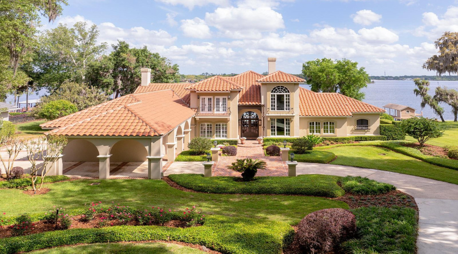Lush Landscaping, Sculptured Flower Beds, Impressive Porte-Cochere. Gas Lanterns, Shutters, Balconies &Amp; Towering Tree Canopies As You Approach This Mediterranean Estate.