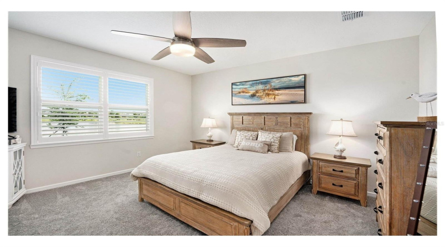 Primary Bedroom Has Carpet And Calming Water Views