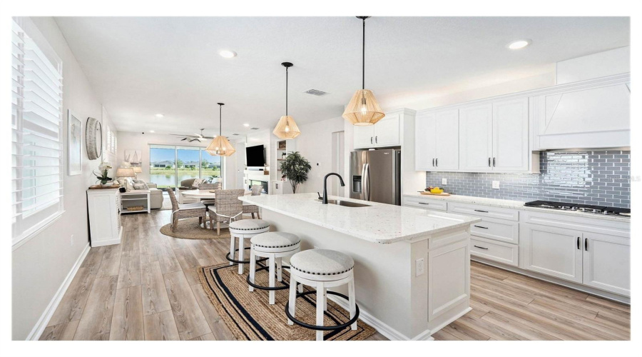 Top Tier Quartz Countertops, Large Basin Sink, Counter Depth Refrigerator, Gas Stove Top With Built In Exhaust Hood. Timeless Tile Backsplash Make The Kitchen Pop