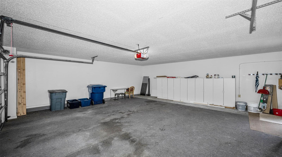 Large Two Car Garage With Storage Cabinets And Shelves.