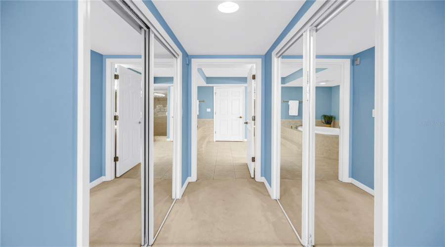 Dual Walk-In Closets In Primary Bedroom Leading To Primary Bathroom