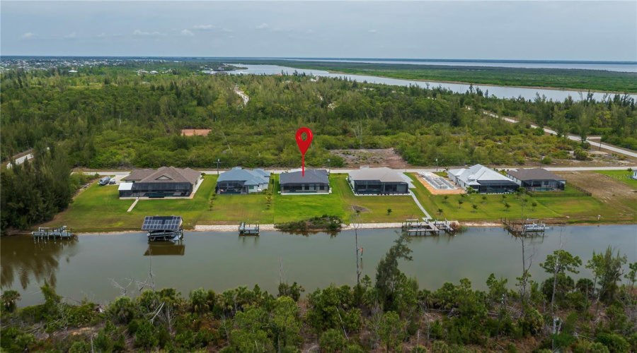 Aerial View Showcasing Waterfront Homesite With Preserve Backdrop.