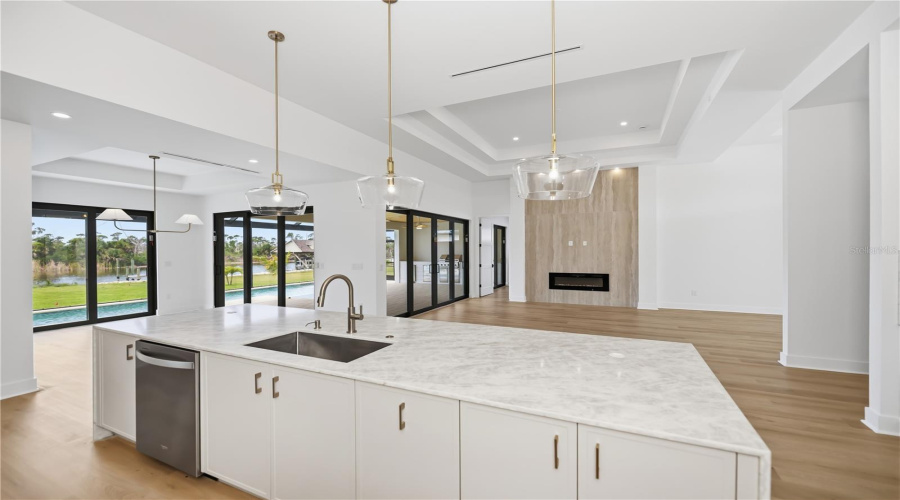 Gourmet Kitchen With Oversized Quartz Waterfall Island.