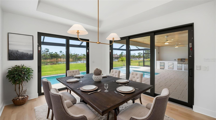 Virtually Staged Dining Area With Pool, Preserve And Water Views.